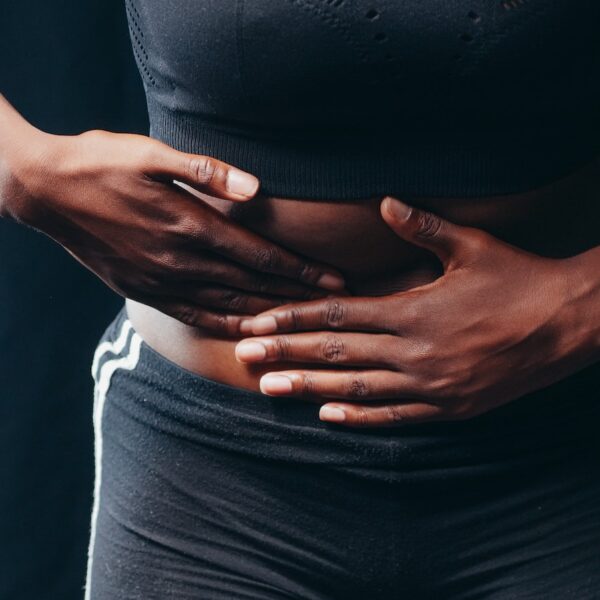 Person Wearing Black Active Wear Holding Her Tummy