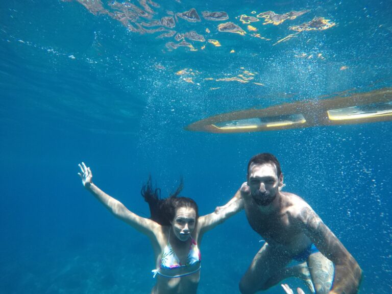 man and woman under the sea water